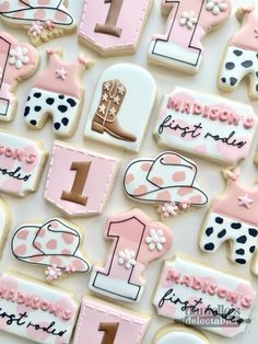 decorated cookies are arranged in the shape of horse boots and numbers for first birthdays