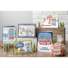 some cards are sitting on a table with christmas decorations and other holiday greetings in front of them