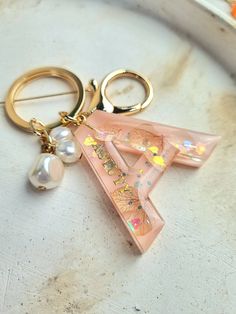 a pair of gold - toned scissors with pink and white designs on them