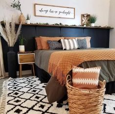 a bedroom with a large bed and baskets on the floor in front of it's headboard