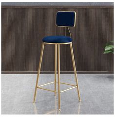 a gold bar stool with a green seat