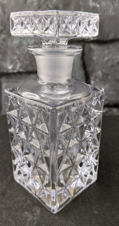 a clear glass bottle sitting on top of a table