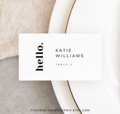 a place card sitting on top of a white plate