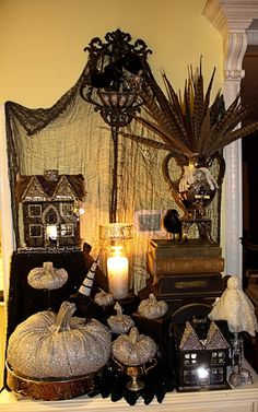 a mantle with candles and halloween decorations on it