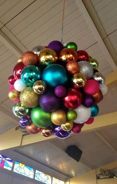 a bunch of christmas ornaments hanging from the ceiling