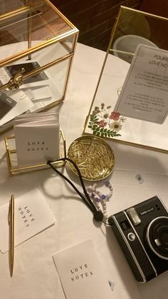 a table topped with lots of cards and an old fashioned camera on top of it