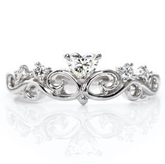 a wedding ring with an intricate design on the side and a diamond center stone in the middle