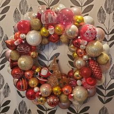 a christmas wreath with ornaments hanging from it