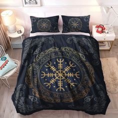 a bed covered in a blue and gold comforter with an intricate design on it