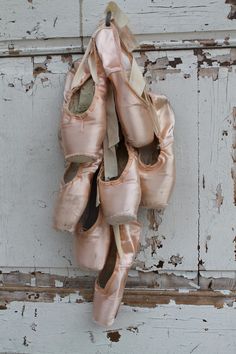 a pair of ballet shoes hanging on a door