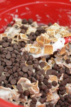 a red bowl filled with chocolate chips and marshmallows