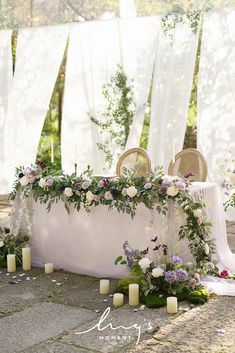 a table with flowers and candles on it