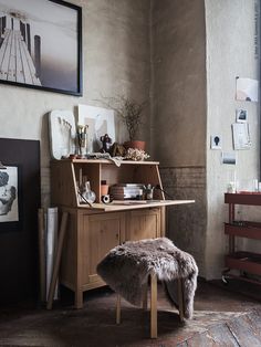 a room with a desk, chair and pictures on the wall