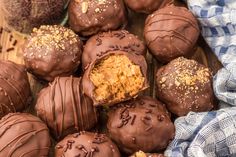 chocolate truffles with peanut butter and sea salt on top, sitting on a wooden surface