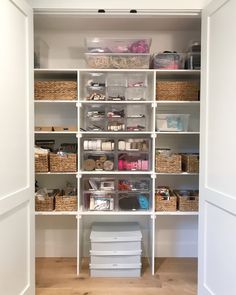 an organized closet with baskets and boxes on the bottom shelf, along with other items