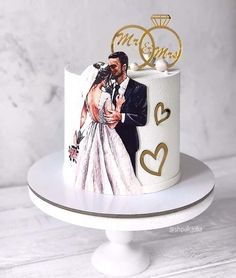 a wedding cake is decorated with an image of a bride and groom