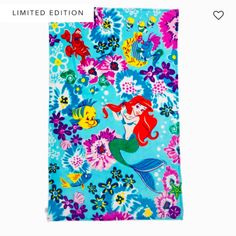 the little mermaid beach towel is blue and has pink flowers on it, while an orange fish