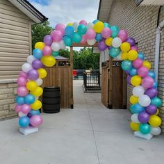 an arch made out of balloons on the side of a building