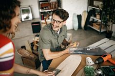 a man and woman working together in a room with woodworking supplies on the floor