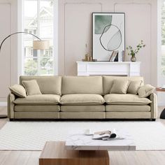 a living room filled with furniture and a painting on the wall