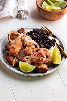 a white plate topped with meat and black beans