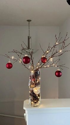 a vase filled with ornaments and lights on top of a table