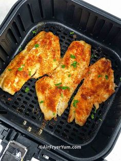 two pieces of chicken are being cooked in a grill grate with parsley on top