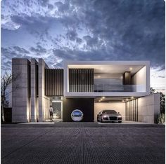 two cars are parked in front of a modern house at dusk with dramatic clouds overhead