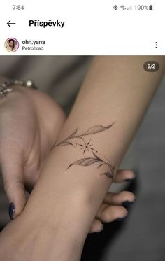 a woman's hand with a small tattoo on it