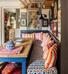 a living room filled with furniture and pictures on the wall