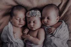 three baby babies sleeping next to each other