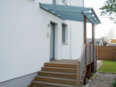 an outside view of a house with steps leading to the front door and patio area