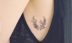 an image of a woman's back shoulder with flowers on the left side of her neck