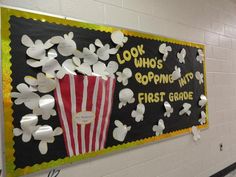 a bulletin board with popcorn and flowers on it in a school hallway or classroom room