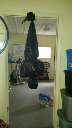 an inflatable ball hangs from the ceiling above a child's play area