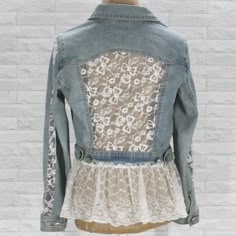 a woman's jean jacket with lace on it