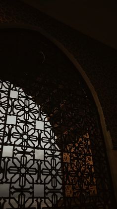 an ornate iron window in the middle of a building