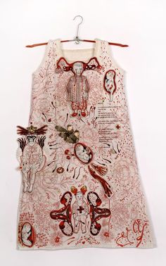 a dress hanging on a clothes hanger with an image of a woman's face