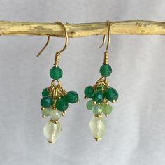 Cluster earrings with faceted oval Prehnite, natural Chrysoprase spheres, faceted green Agate spheres. Open hook. All components are in gold-plated 925 silver. Artisanal creation, made by hand. Earrings length: 4 cm (1.57 inch) Prehnite: 7.5/6 mm. Chrysoprase: 3.5/4 mm. Green agate: 4 mm. After checking and cleaning, they will be packaged in a nice gift box. Unique piece ready for delivery. Green Gemstone Bead Drop Earrings, Green Gemstone Round Bead Earrings, Green Gemstone Earrings With Round Beads, Elegant Green Gemstone Beaded Earrings, Green Round Gemstone Bead Earrings, Green Gemstone Beaded Round Earrings, Green Gemstone Beads Round Earrings, Green Briolette Earrings For Gifts, Green Onyx Earrings For May Birthstone