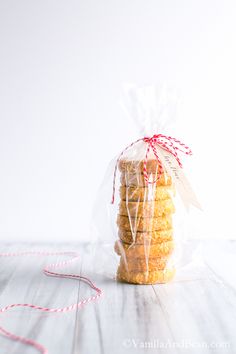 a bag filled with cookies sitting on top of a wooden table next to a string