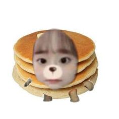 a stack of pancakes with a face in the middle and an image of a person's head on top