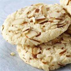 three cookies with almonds are stacked on top of each other