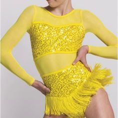 a woman in a yellow leotard with her hands on her hips and one hand on her hip