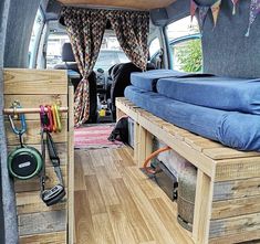 the inside of a van with wooden pallets and storage space for various items in it