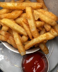 french fries with ketchup in a bowl on a plate