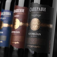 several bottles of wine lined up on a shelf