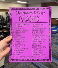 a hand holding up a pink classroom stop checklist