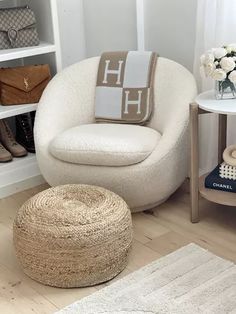 a white chair and ottoman in a room