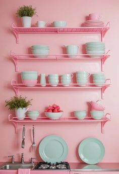 pink shelves with plates and bowls on them