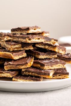 a white plate topped with chocolate covered pretzels